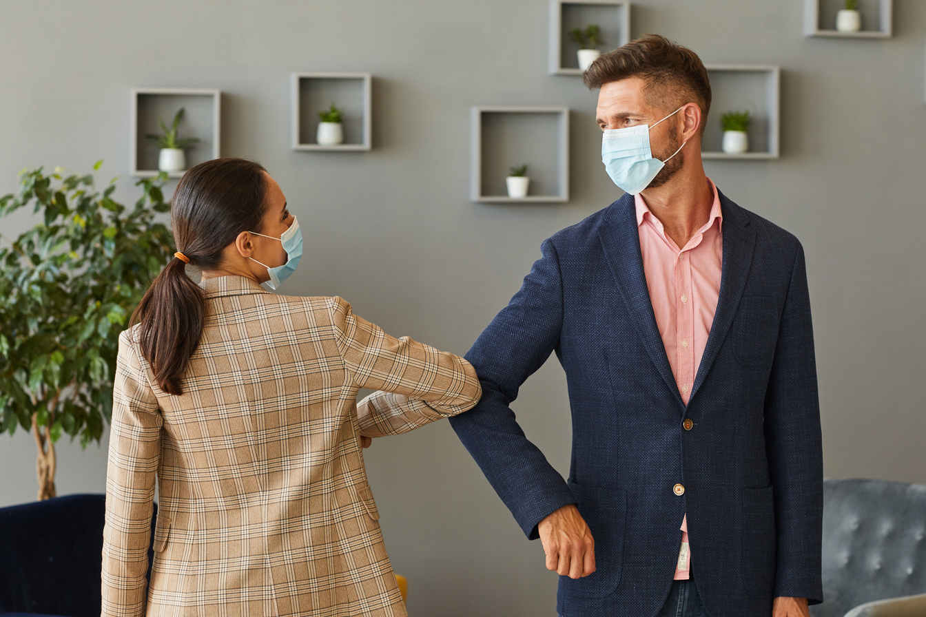 Colleagues Bumping Elbows in Post Pandemic Office